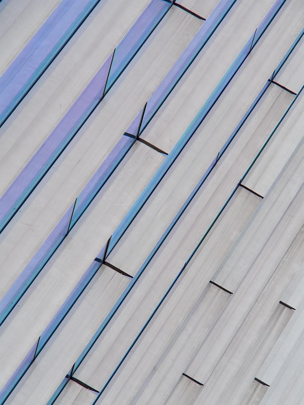 Free Image of Modern architectural design featuring sleek glass and concrete facade with lines 