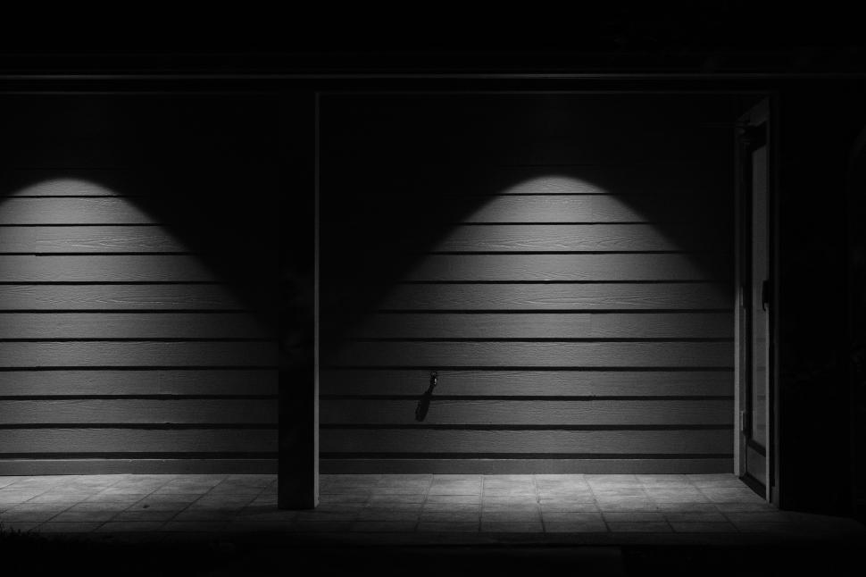 Free Image of Lighting creates dramatic shadows on modern exterior wall at night 