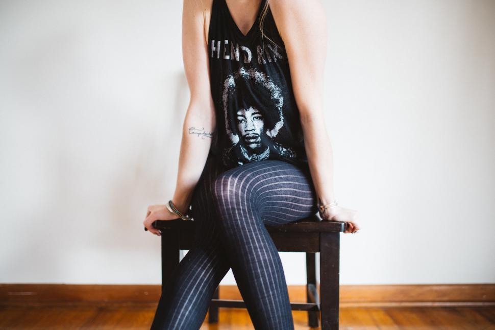Free Image of Confident woman in stylish outfit on a chair 