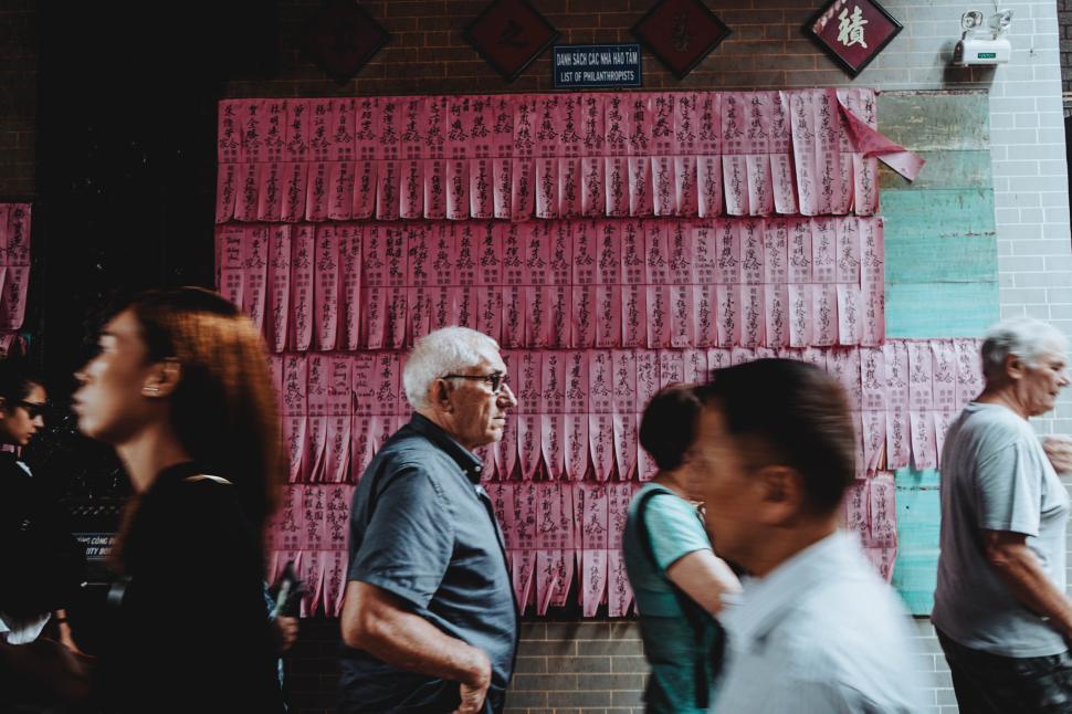 Free Image of Busy street with pedestrians and cultural display in vibrant city 