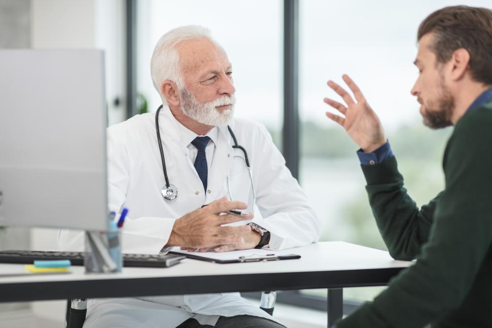 https://freerangestock.com/sample/191345/doctor-consulting-with-patient-in-modern-medical-office.jpg