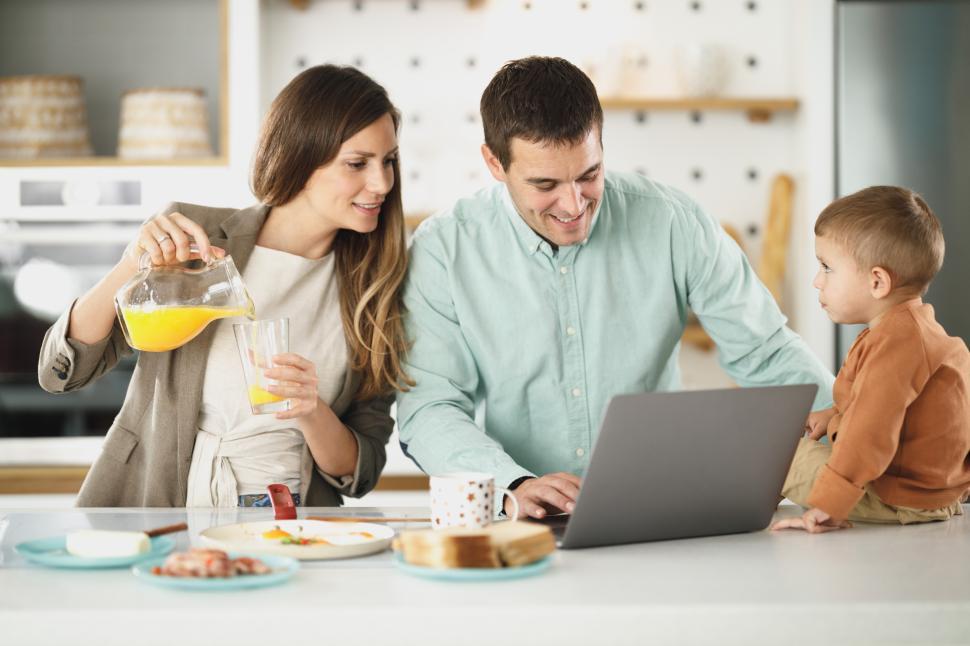 Free Image of Family enjoying breakfast together while working from home 