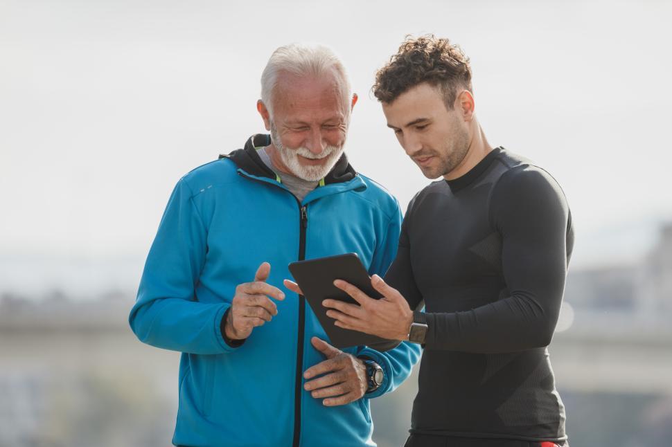Free Image of Elderly man learning from athletic trainer outdoors at daytime 