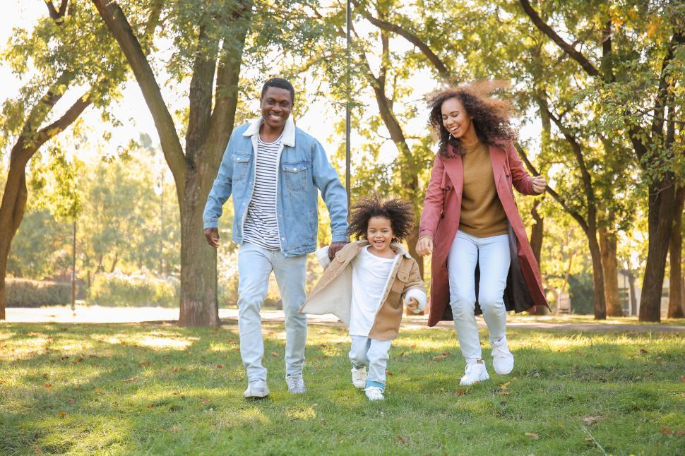 Free Image of Family enjoying a sunny day in the park with playful moments in autumn 