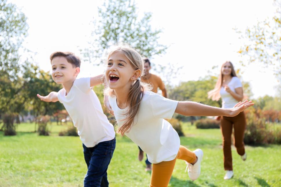 Free Image of Happy children playing in a sunny park during spring 