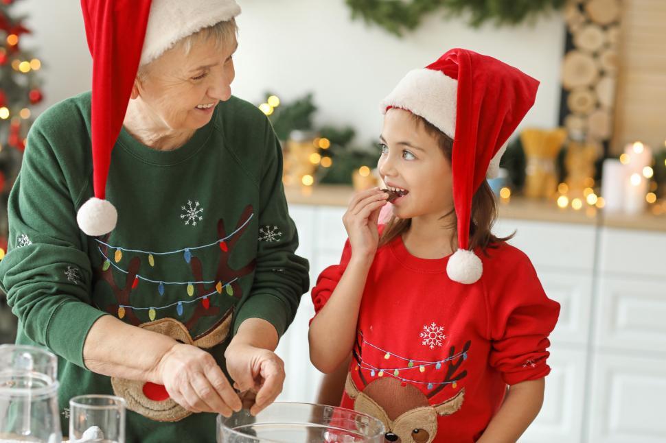 Free Image of Grandmother and granddaughter baking cookies for Christmas 