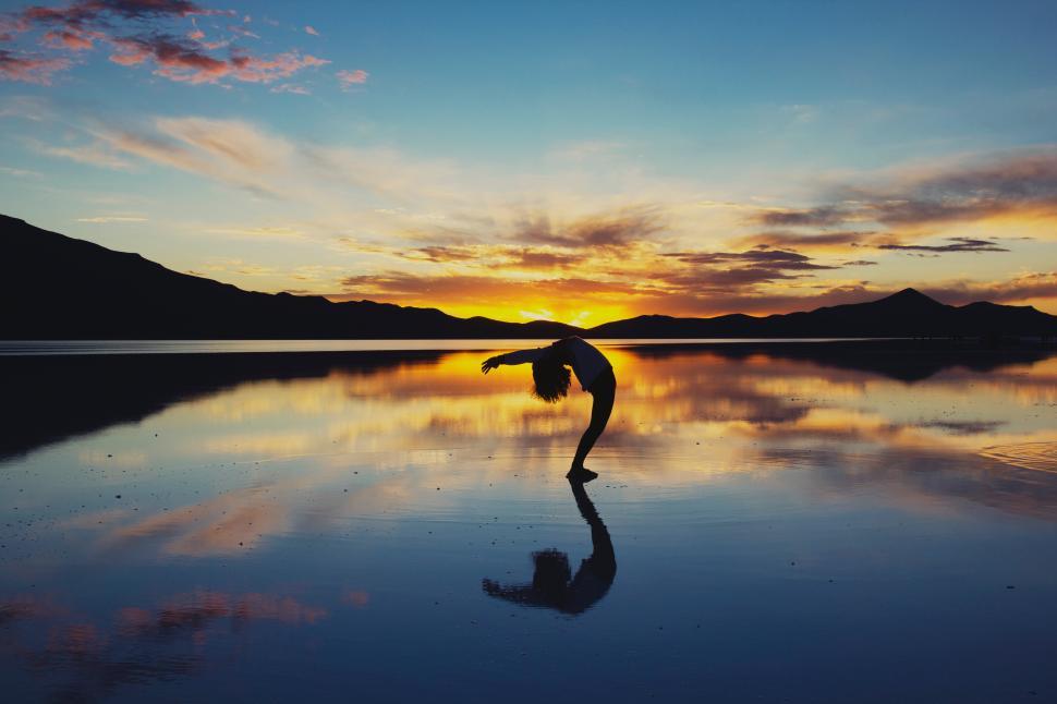 Free Image of Silhouette of a dancer against a sunset backdrop 