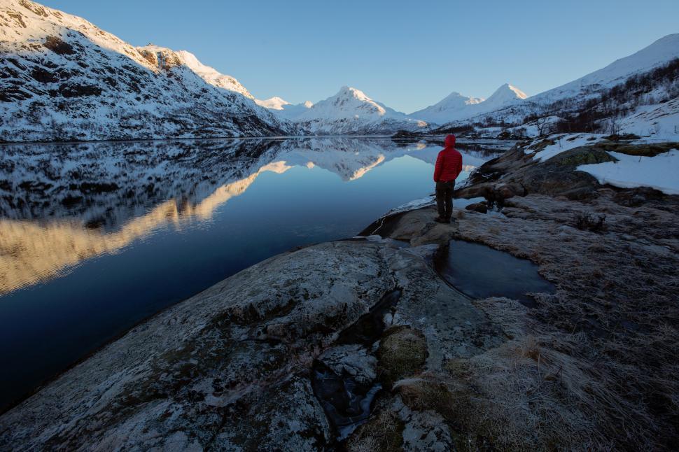 Free Image of Winter landscape reflection in a fjord with a hiker 