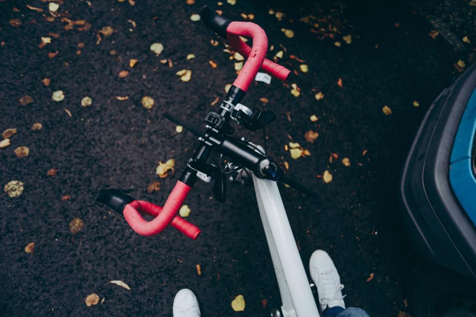 Free Image of Cyclist preparing for a ride on a wet autumn day 