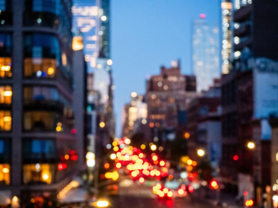 Free Image of City skyline at dusk with blurred lights and modern architecture 