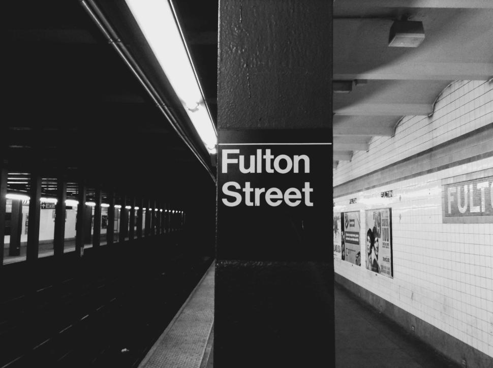 Free Image of Fulton Street subway station sign in New York City at night 