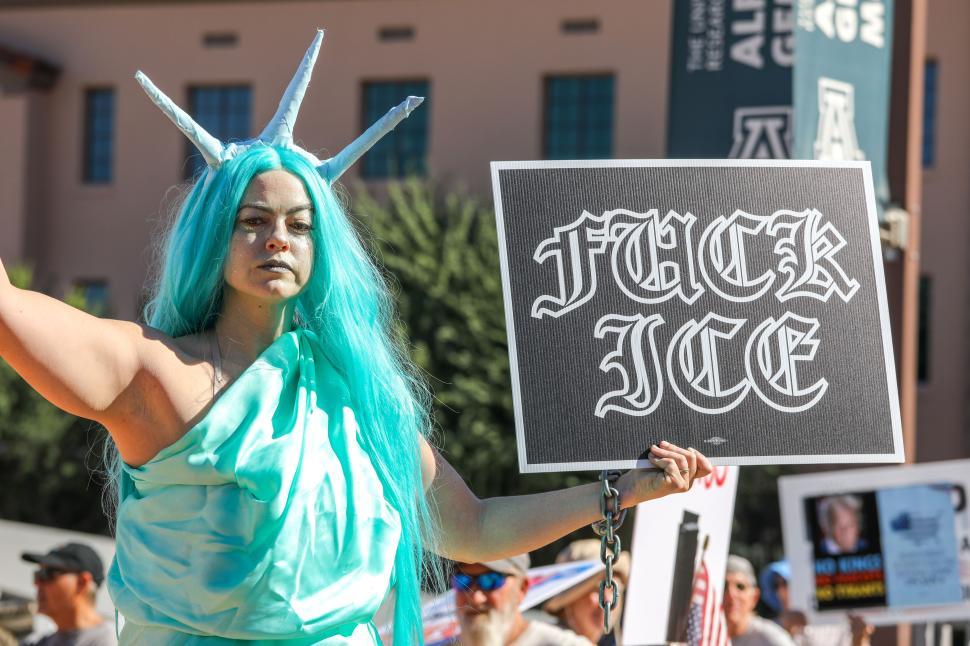 Free Image of Protester dressed as Statue of Liberty advocates against ICE at political rally 