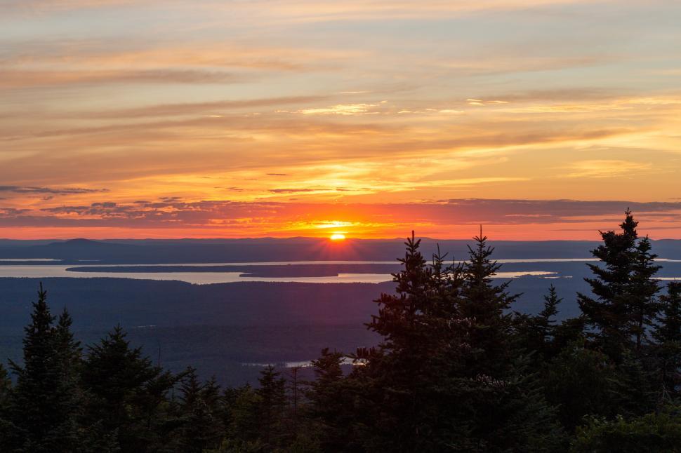 Free Image of Sunset over mountains and lakes in the evening sky 