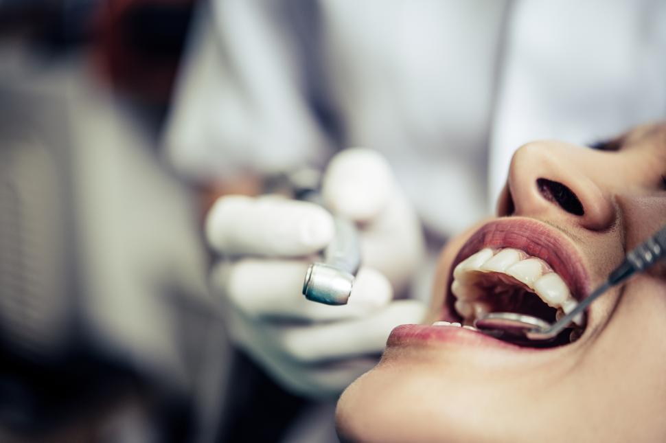 Free Image of The dentist examines the patient s teeth. 