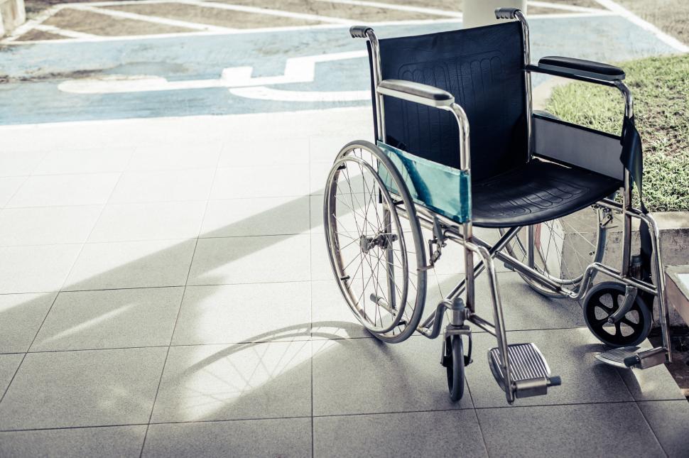 Free Image of Patient wheelchairs parked in front of the hospital 