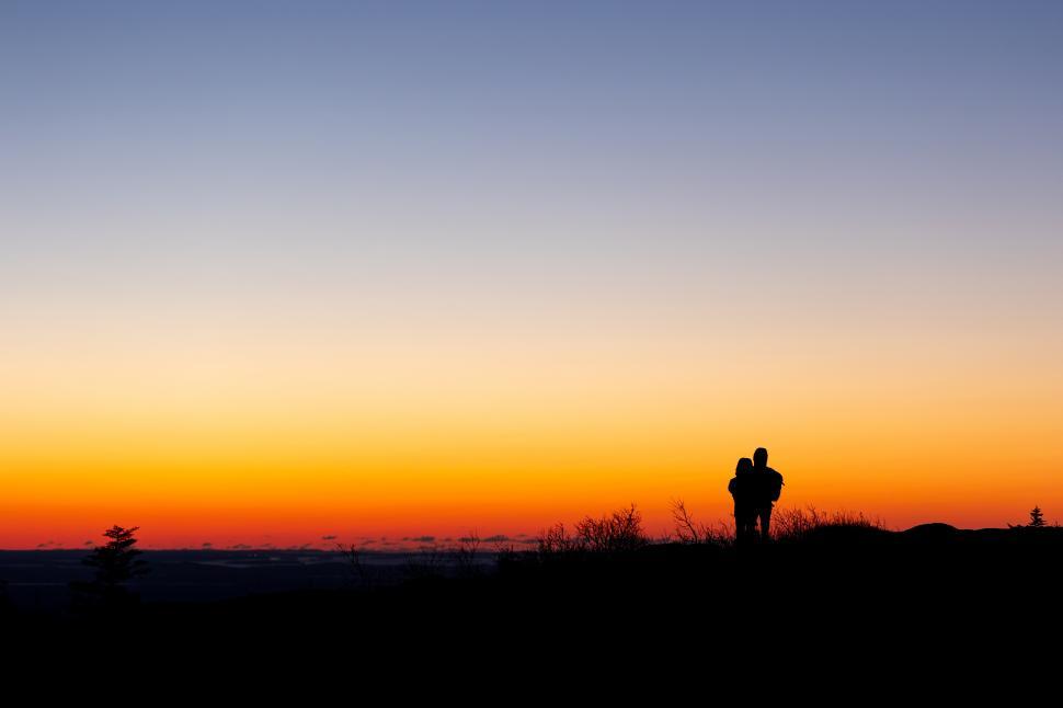Free Image of Romantic sunset view with couple on a mountain top 