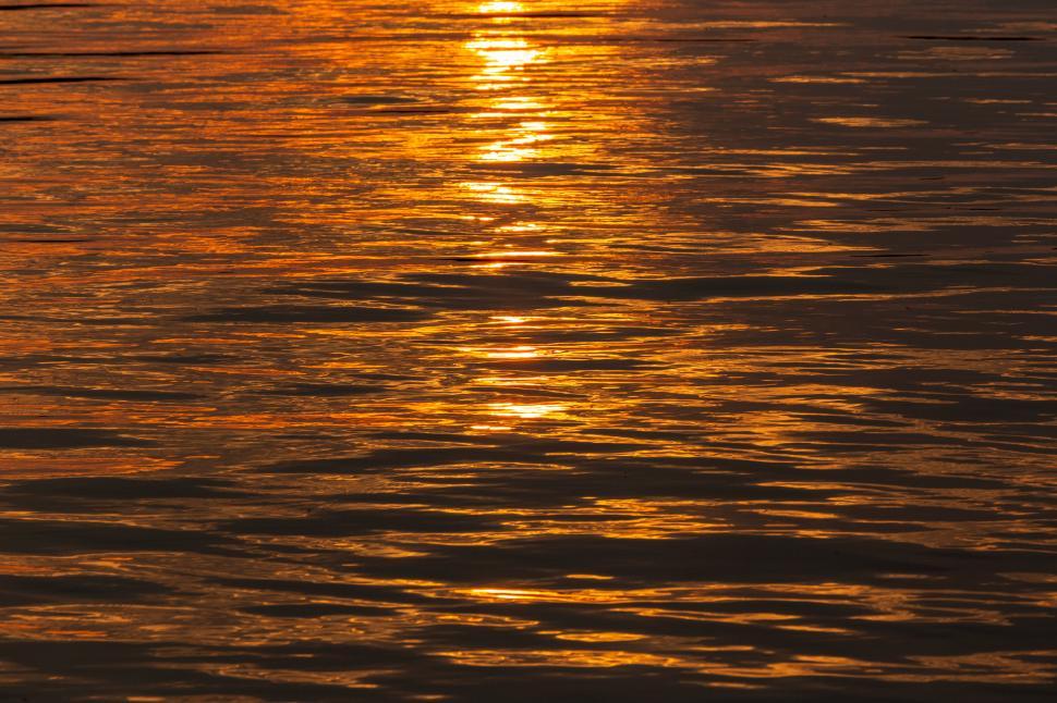 Free Image of Tranquil sunset reflections on calm water surface 