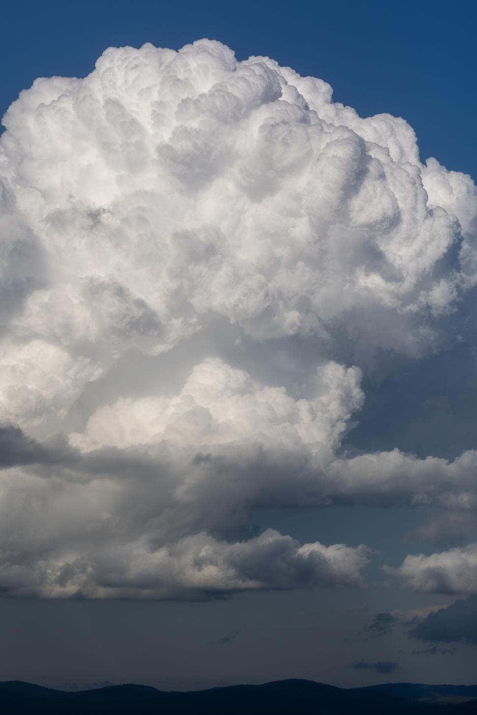 Free Image of Dramatic white clouds fill the blue sky at midday 