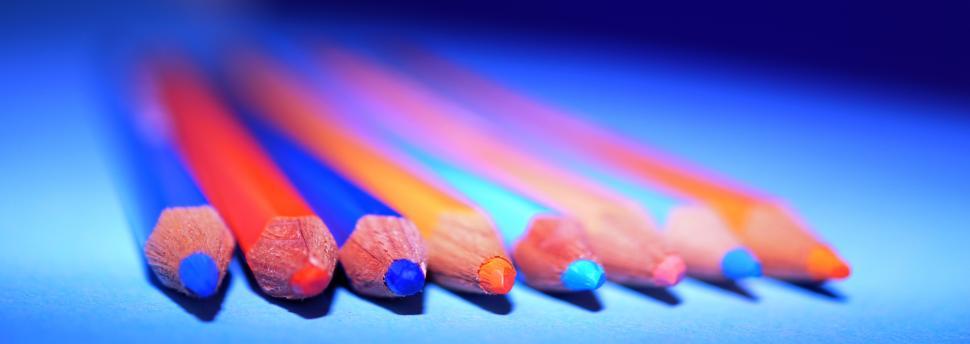 Free Image of Colorful pencils arranged in vibrant pattern on flat surface 