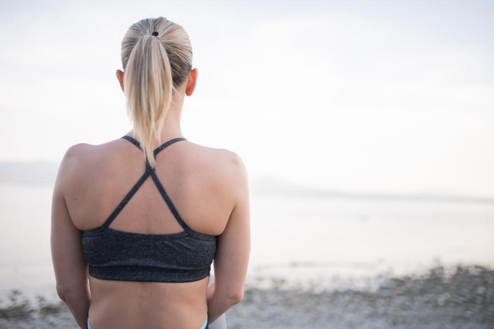 Free Image of Woman enjoying a serene moment by the water 