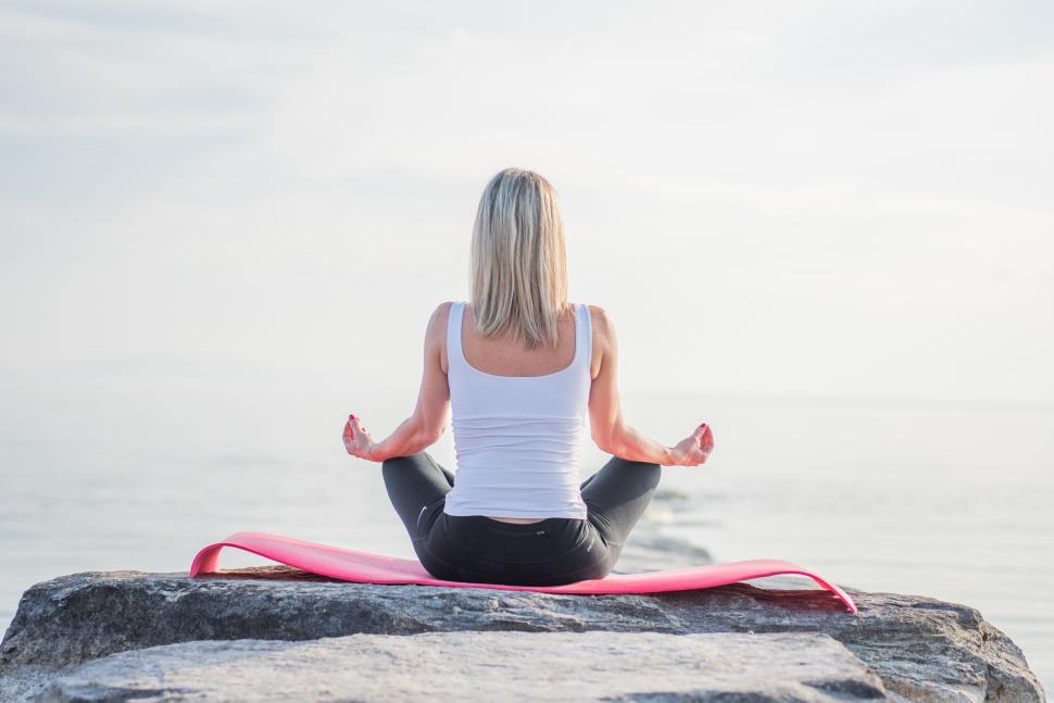 Free Image of Practicing yoga by the calm sea at dawn 