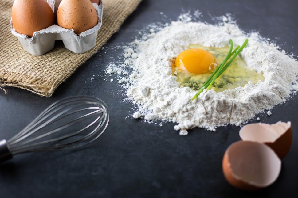Free Image of Preparing dough with egg and flour on table 
