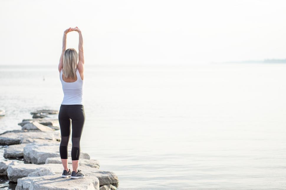 Free Image of Stretching by the water at sunrise 