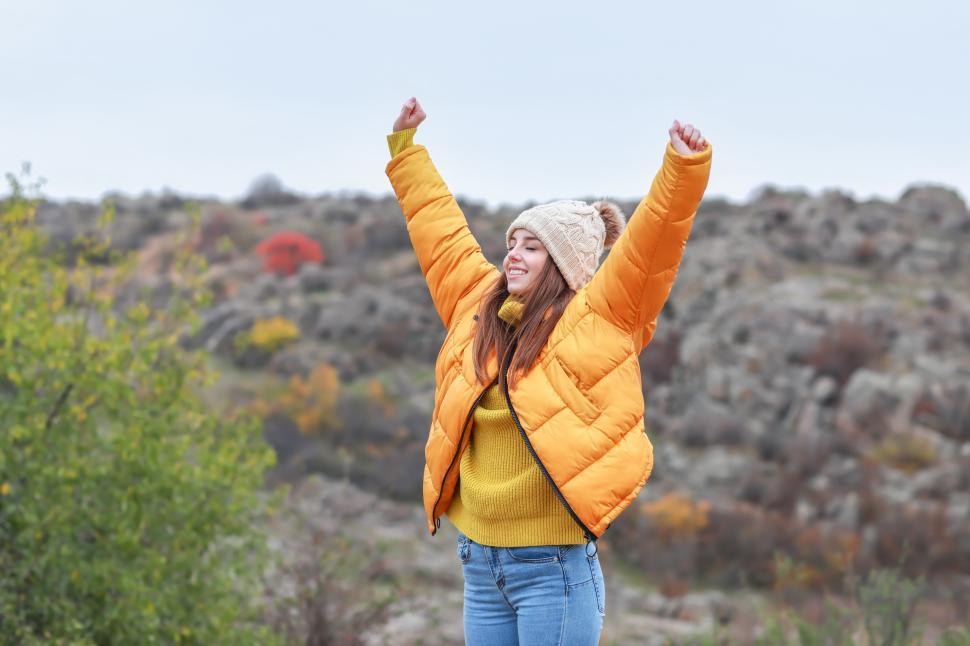Free Image of Enjoying a joyful moment outdoors in a cozy winter outfit 
