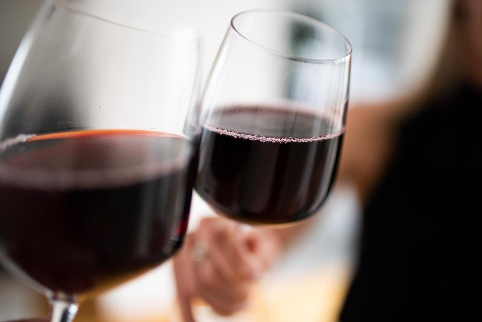 Free Image of Cheers to friendship with red wine in cozy setting 