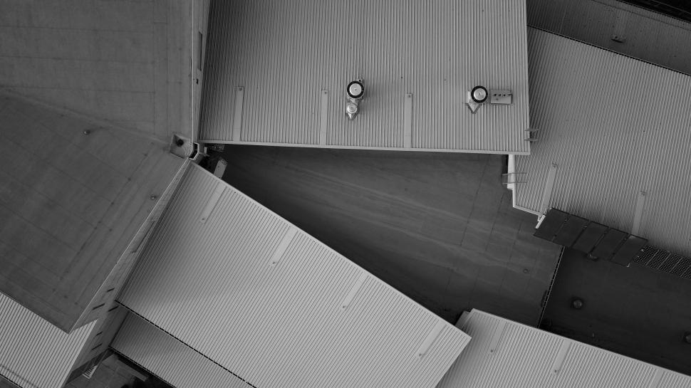 Free Image of This aerial perspective captures the geometric arrangement of rooftops in a city 
