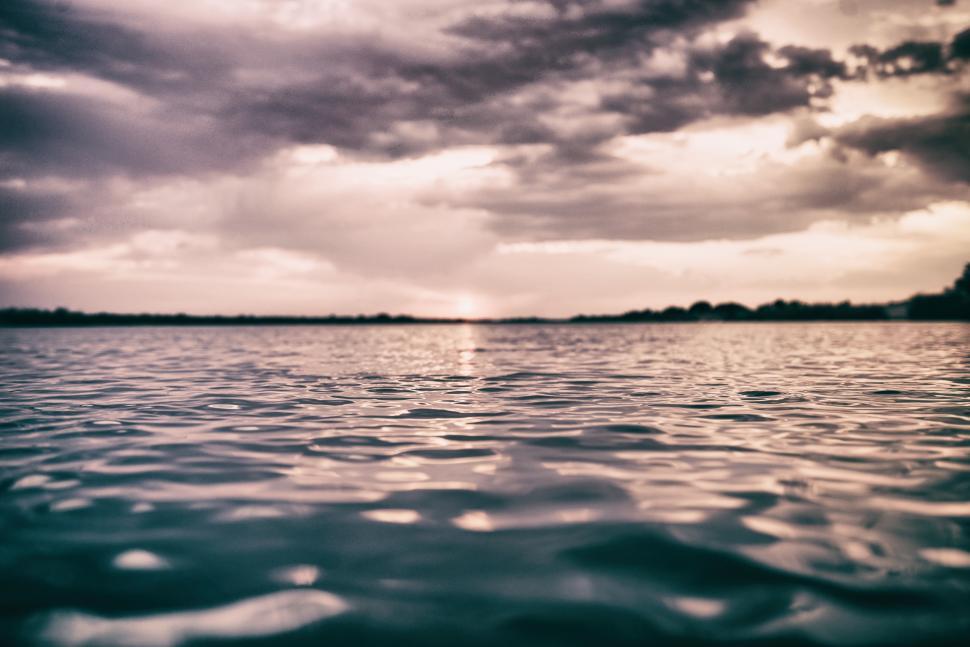 Free Image of Evening reflections on the calm water surface 