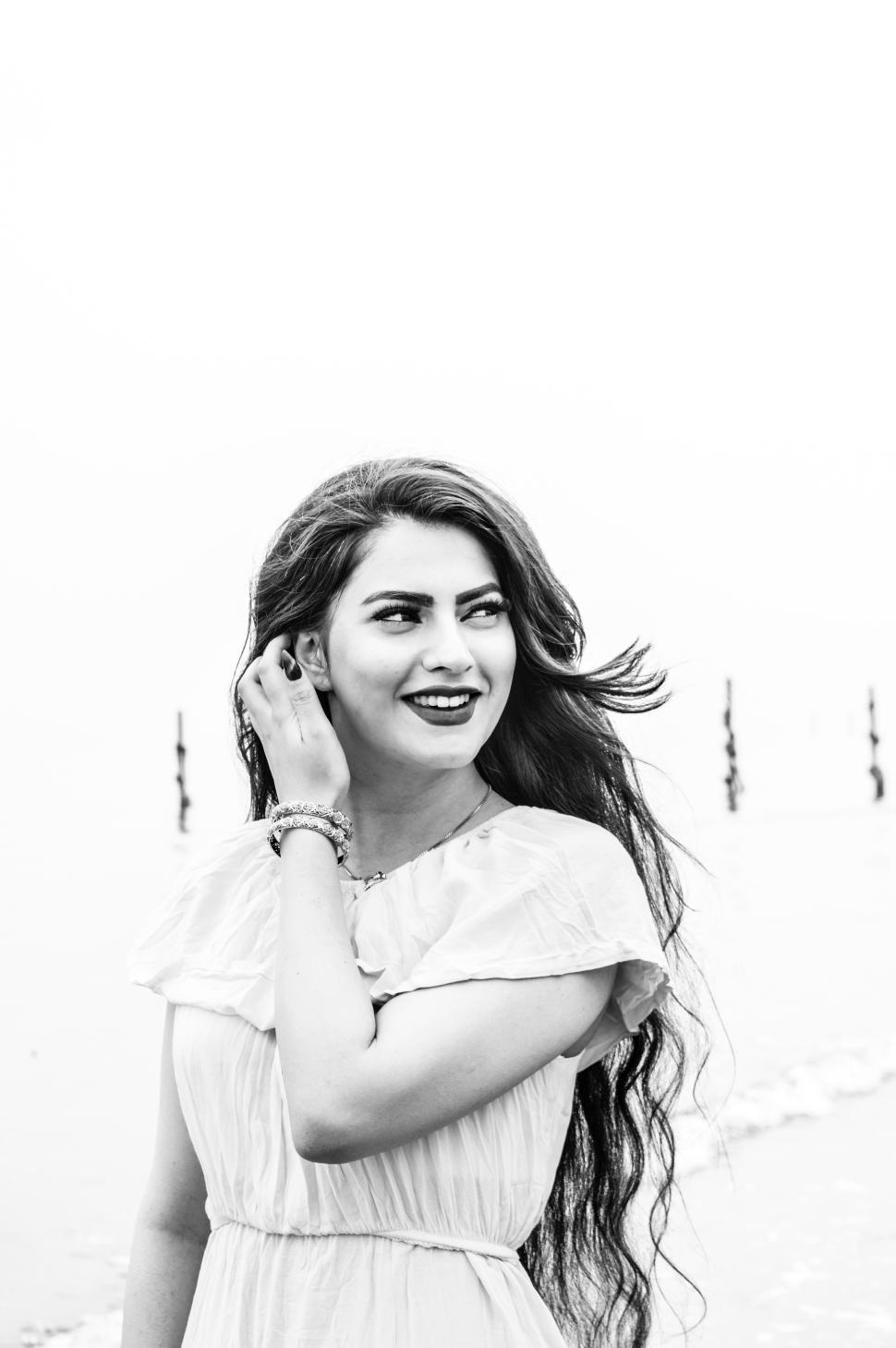 Free Image of Woman enjoying a serene moment by the shore 