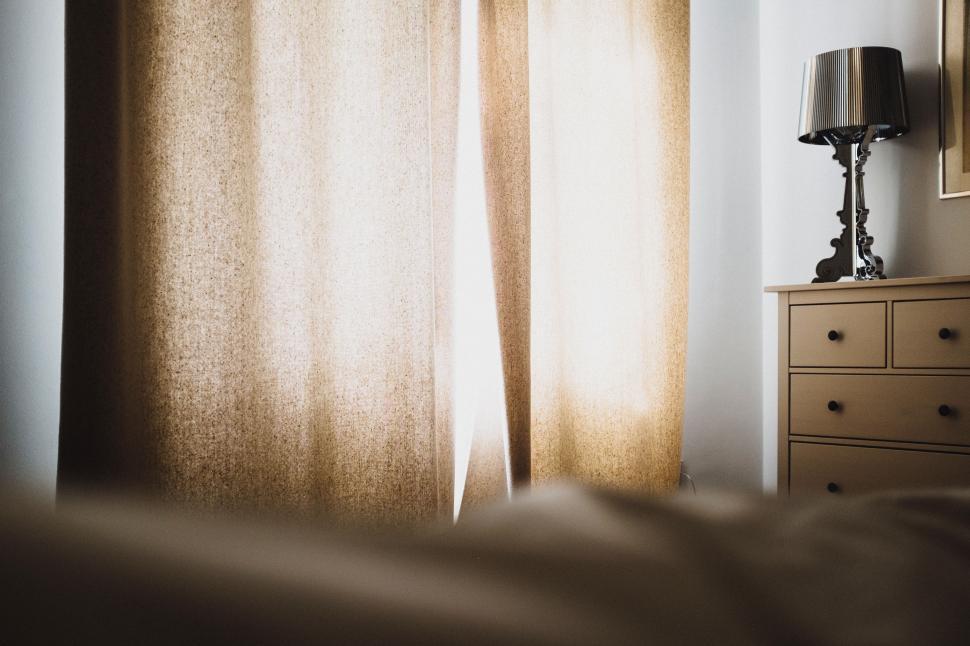 Free Image of Natural light filters through curtains in peaceful bedroom 