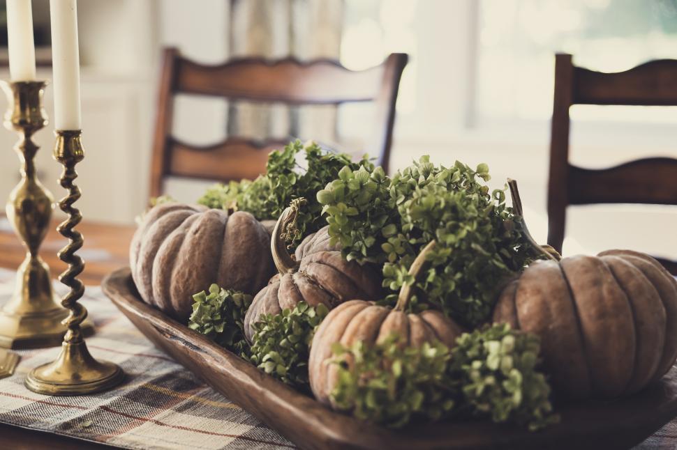 Free Image of Pumpkins and greenery create a cozy autumn centerpiece for dining 