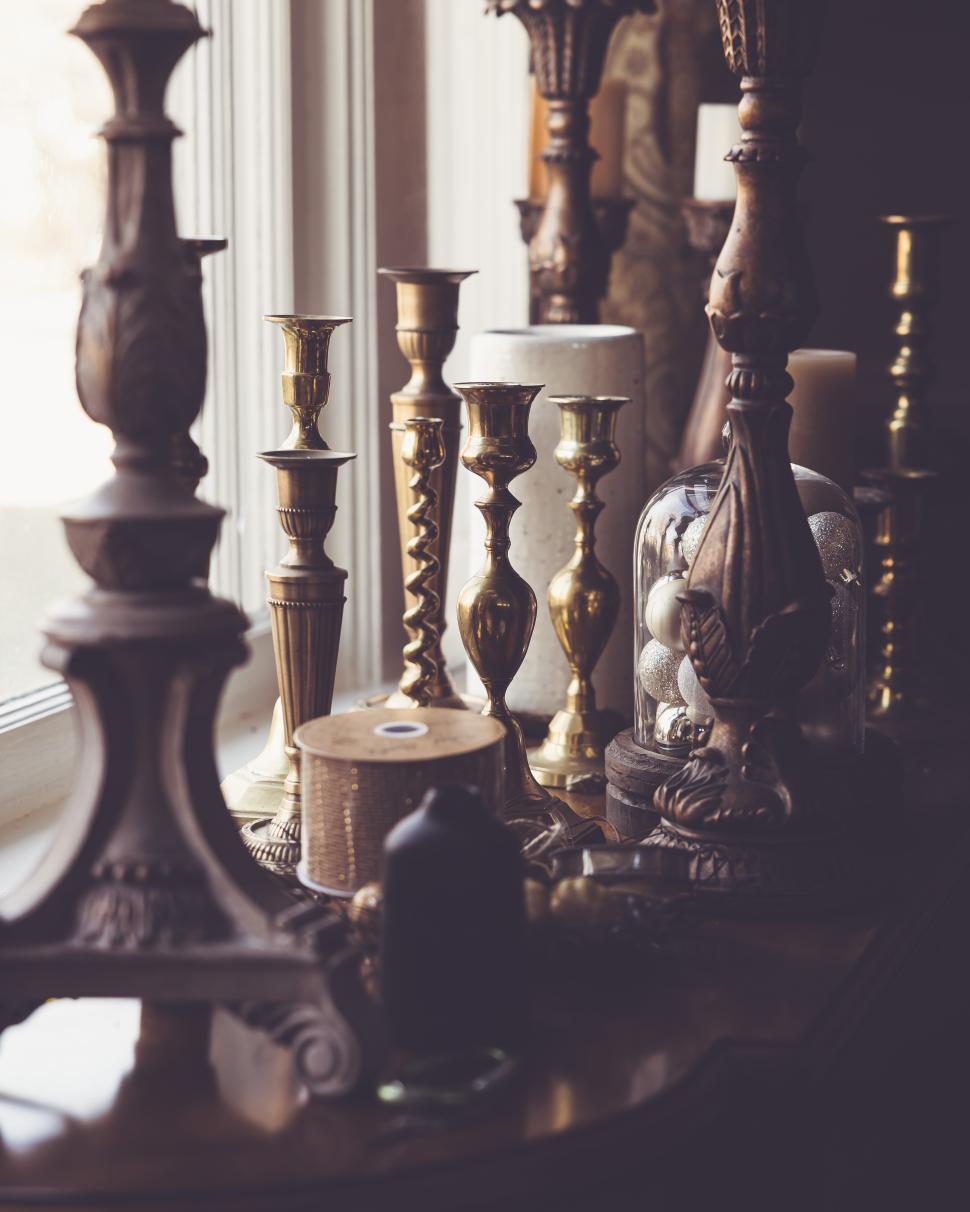 Free Image of Collection of vintage candleholders and decorative items on display 