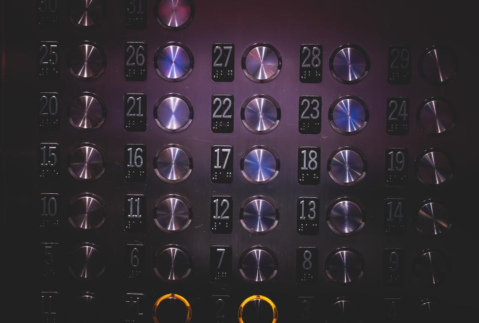 Free Image of Elevator buttons illuminated in a modern building interior 