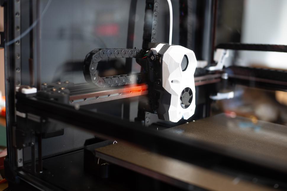 Free Image of 3D printer in action creating intricate designs 
