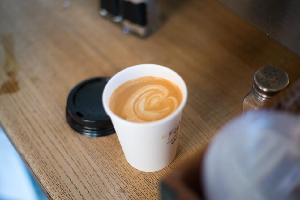Free Image of Perfect latte art displayed in a cozy cafe setting 
