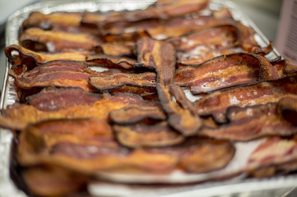 Free Image of Crispy bacon strips ready to serve at a breakfast gathering in the kitchen 