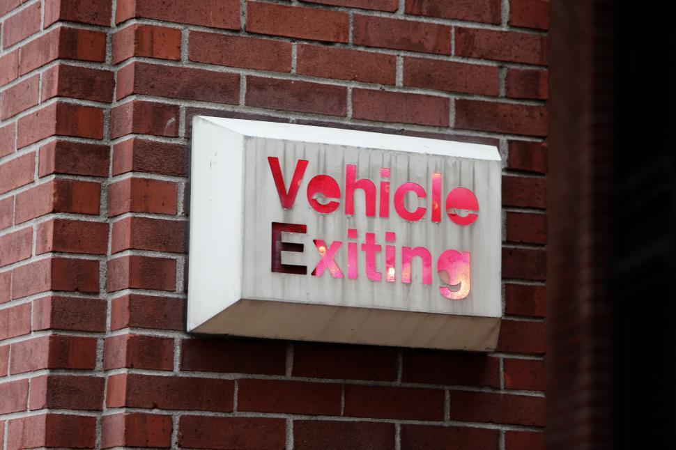 Free Image of Sign indicating vehicle exiting in urban area 