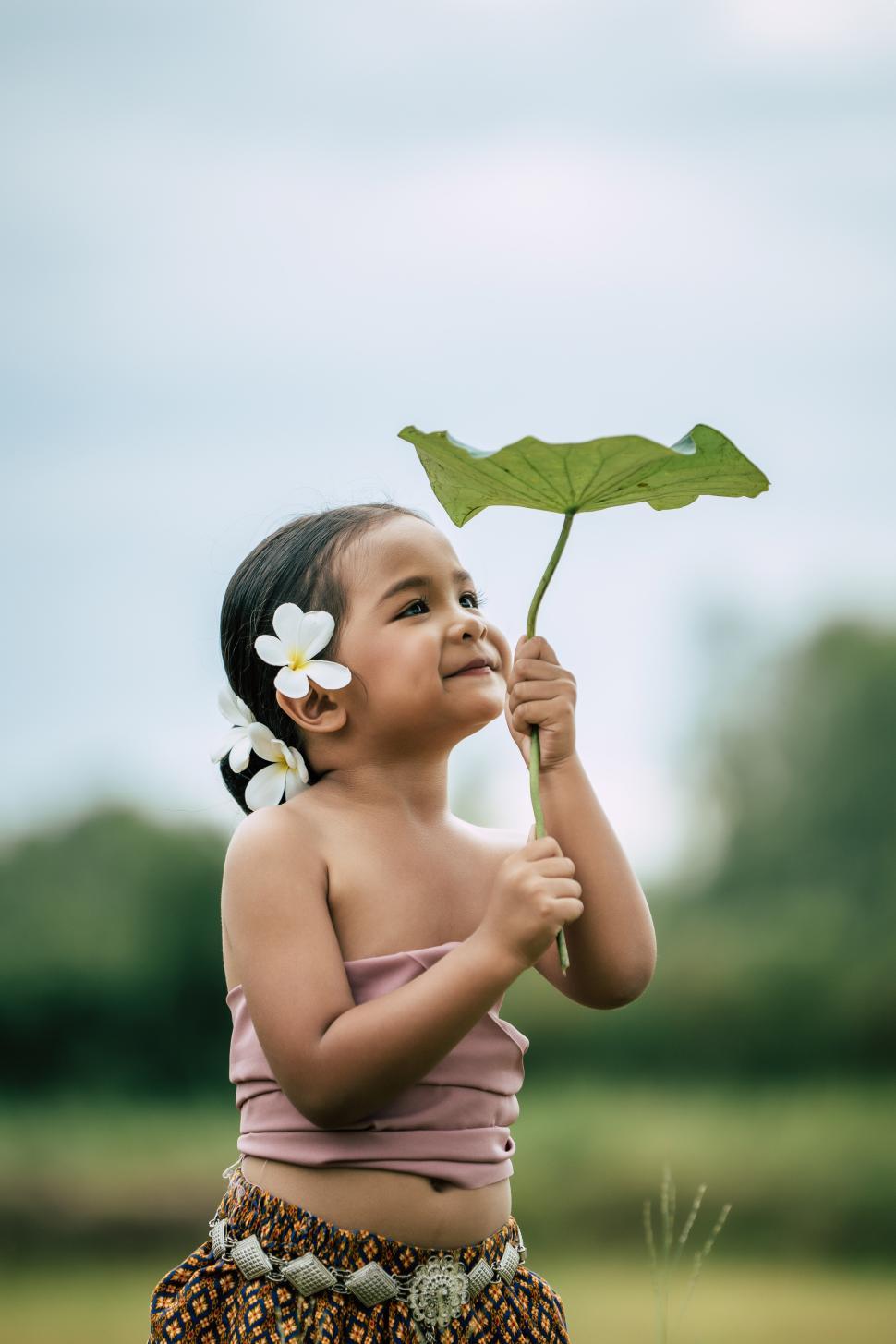 Free Image of Cute girls in Thai traditional dress holding leaf of lotus 
