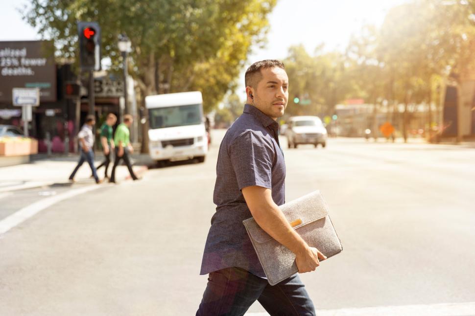 Free Image of Man crossing street in urban environment during daylight 