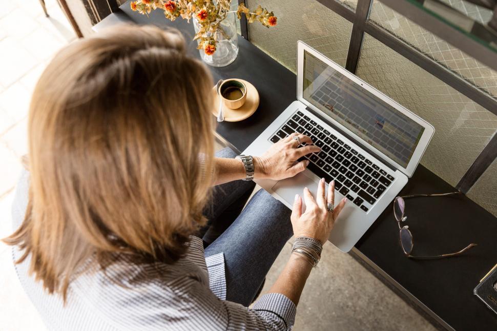 Free Image of Focused individual working on laptop at cozy workspace 