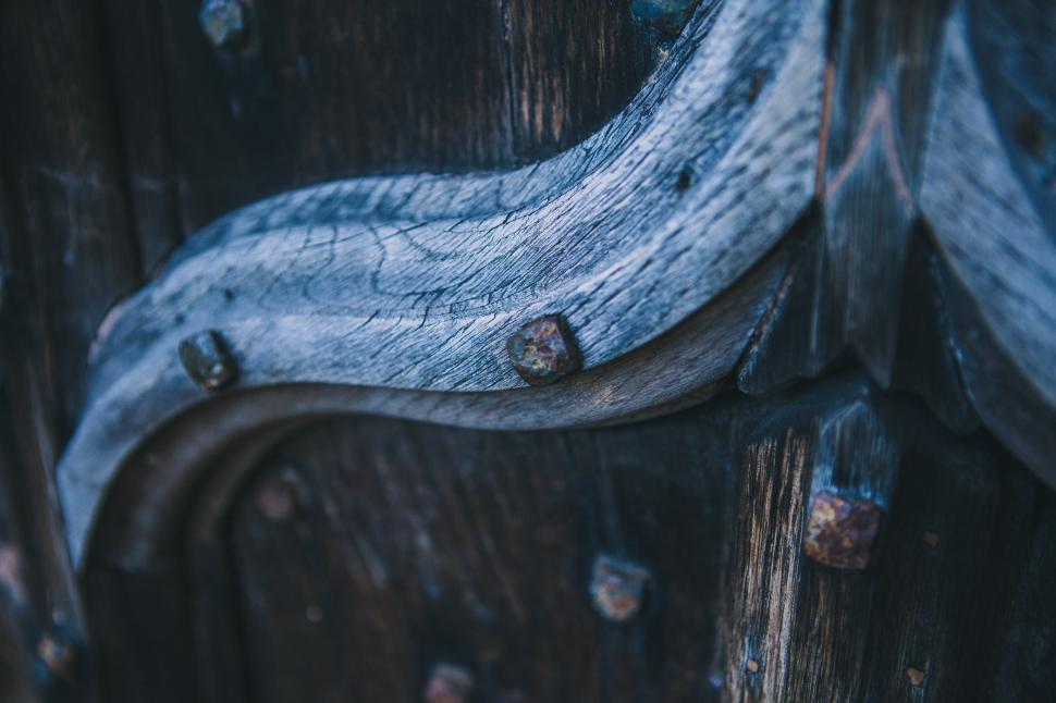 Free Image of Close-up of an ancient wooden door with metal 