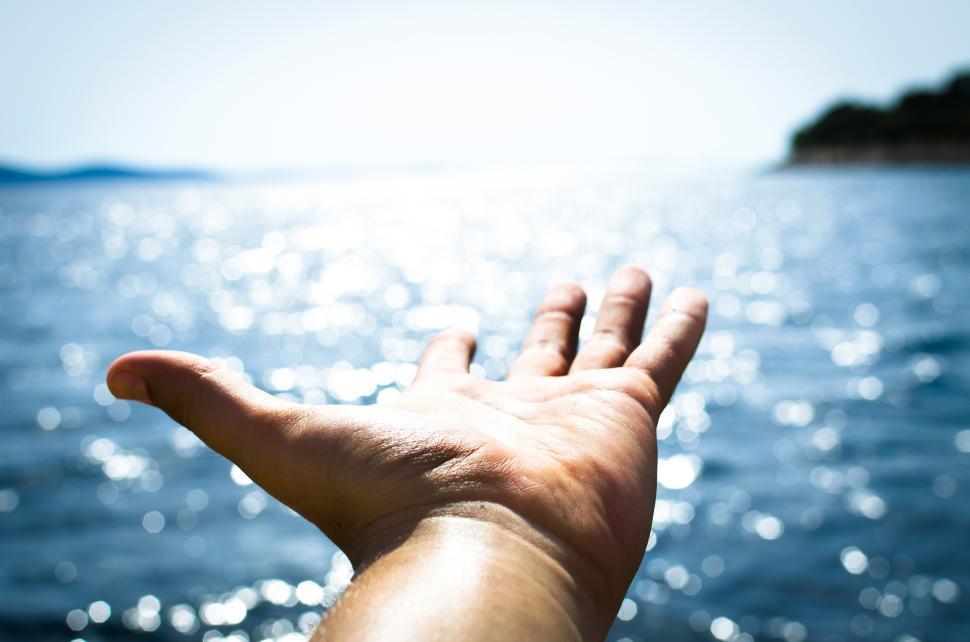 Free Image of Man enjoys freedom on open sea under bright sunlight 
