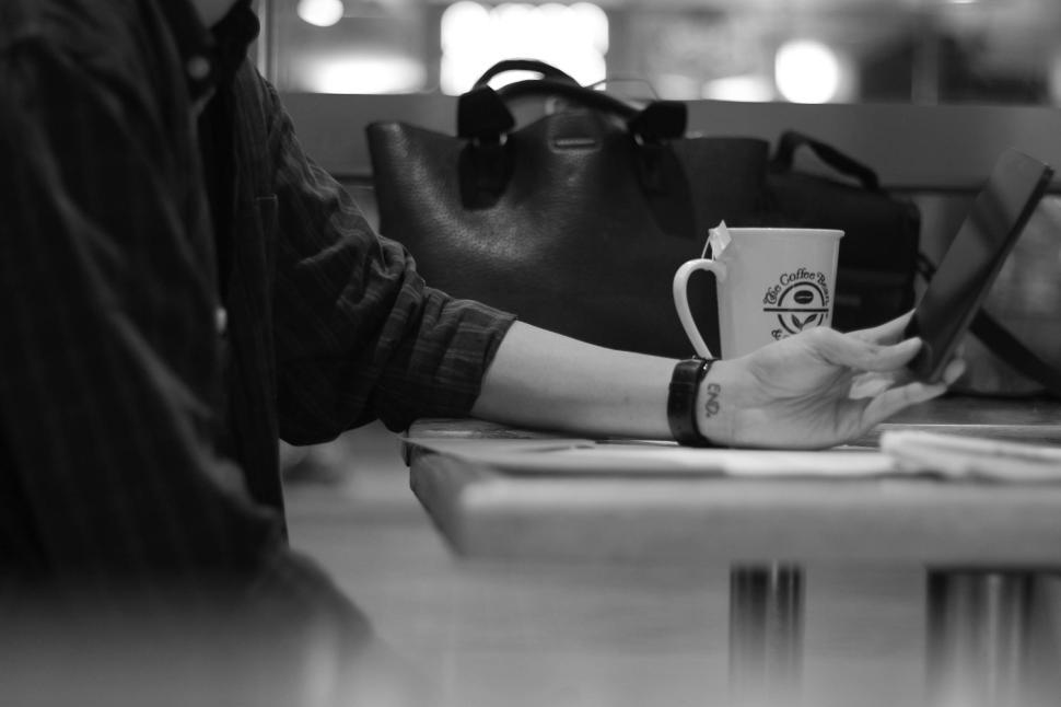 Free Image of Enjoying a quiet moment with coffee and a smartphone 