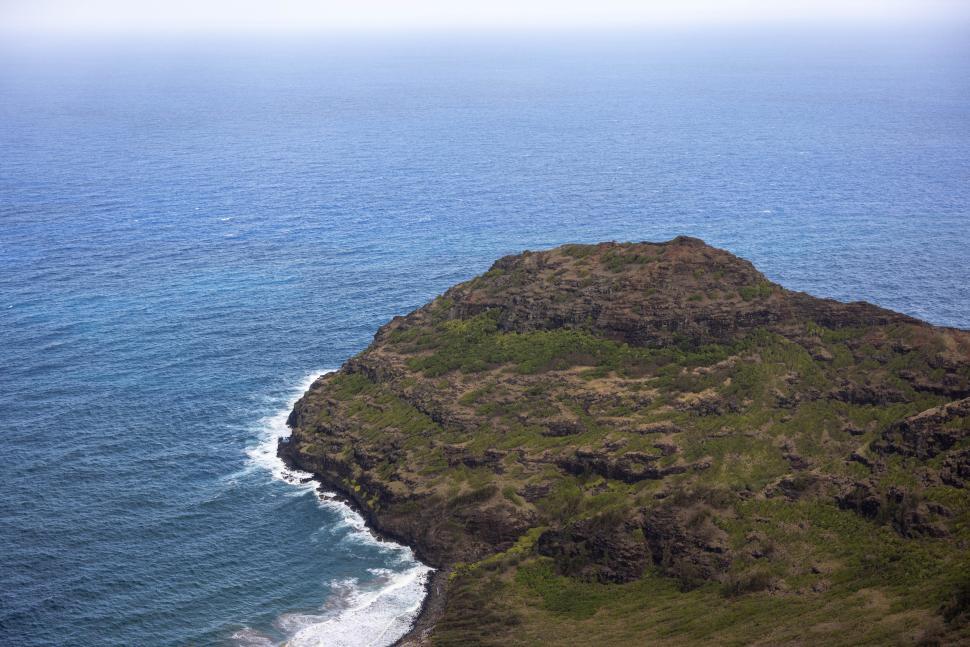 Free Image of Coastal landscape showcasing rocky cliffs and ocean waves in daylight 
