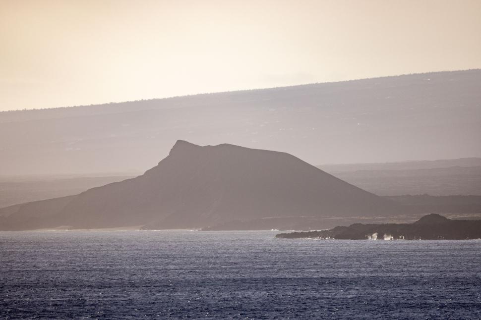 Free Image of Scenic coastal view with distant volcanic island at sunset 