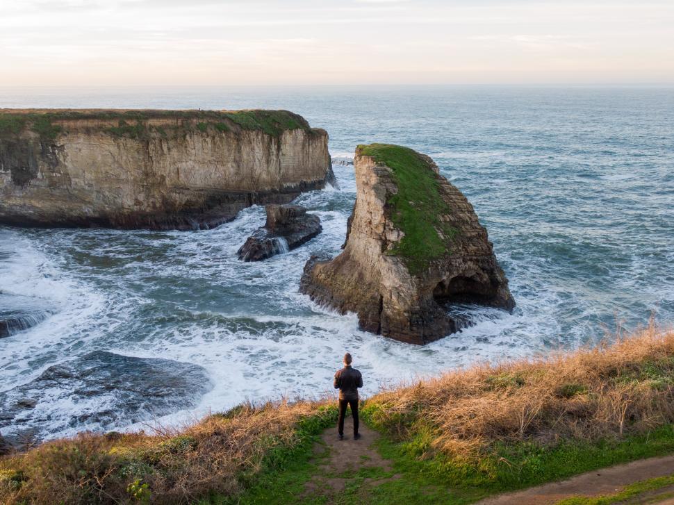 Free Image of Dramatic coastal view with rocky formations at sunset time 
