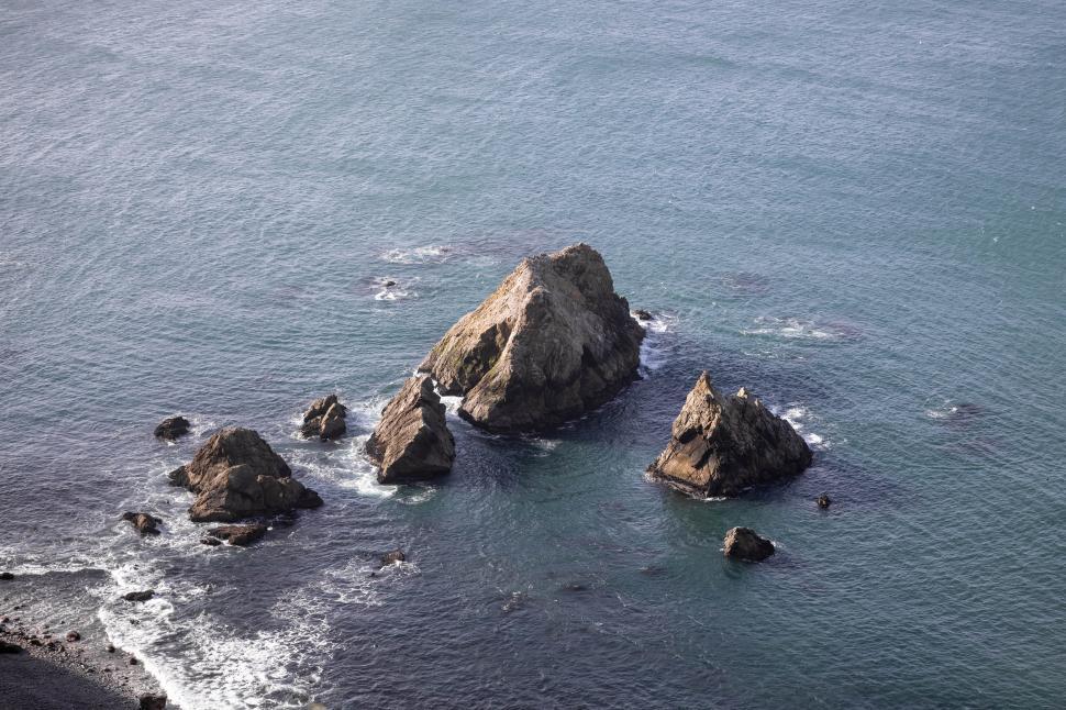 Free Image of Stunning coastal view of rocky formations on a calm sea 